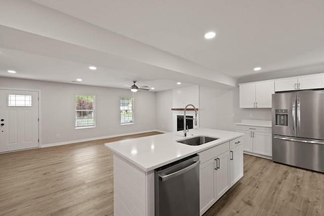 kitchen featuring a sink, light countertops, light wood-style floors, stainless steel appliances, and recessed lighting