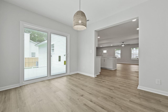 unfurnished dining area with recessed lighting, baseboards, ceiling fan, and light wood-type flooring
