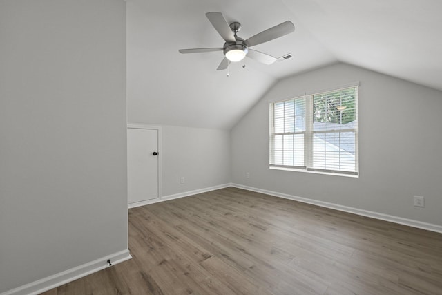bonus room featuring a ceiling fan, baseboards, visible vents, and wood finished floors