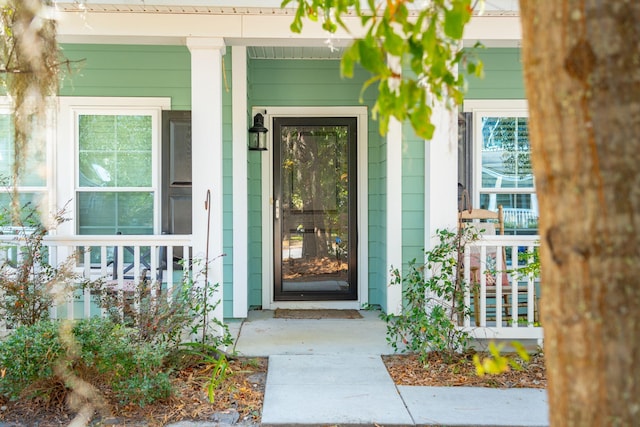 view of exterior entry with a porch