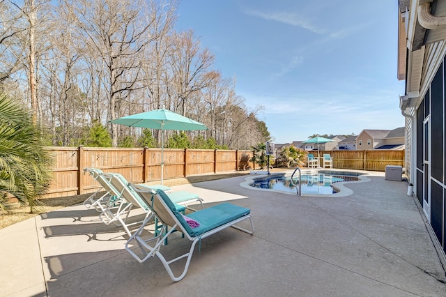 view of swimming pool with a fenced in pool, a fenced backyard, and a patio