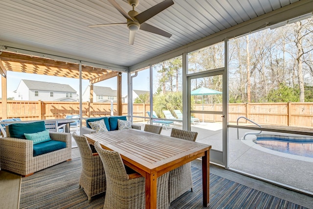 sunroom / solarium featuring ceiling fan