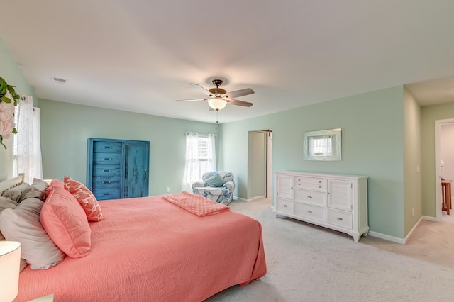 bedroom with baseboards, ceiling fan, and light colored carpet