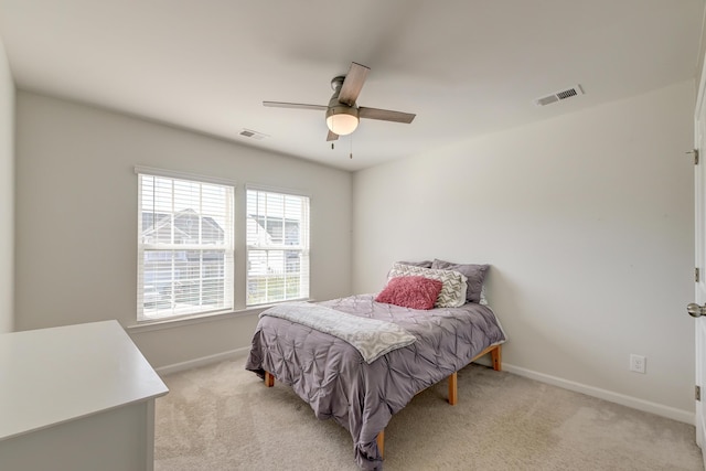 bedroom featuring light carpet, baseboards, visible vents, and a ceiling fan