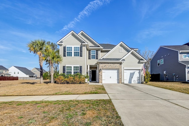 view of front of home featuring a garage, concrete driveway, a front lawn, and fence