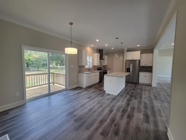 kitchen featuring stainless steel appliances, a kitchen island, white cabinetry, decorative light fixtures, and decorative backsplash