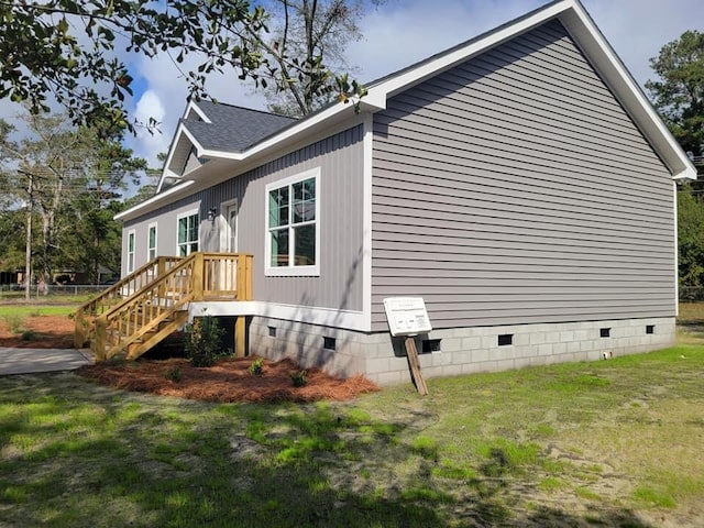 view of side of home with a lawn