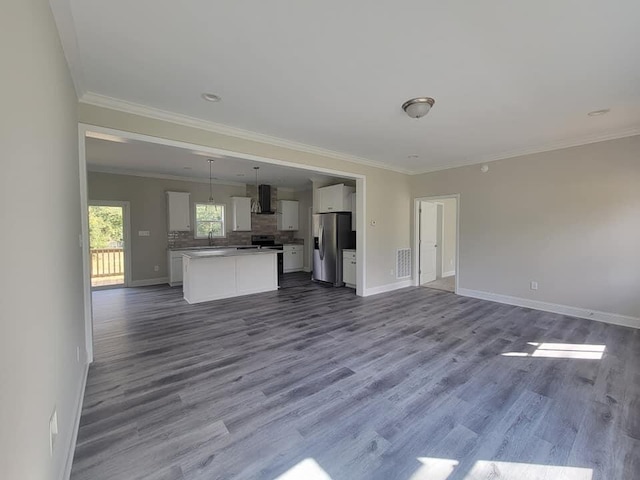 unfurnished living room featuring ornamental molding and hardwood / wood-style floors