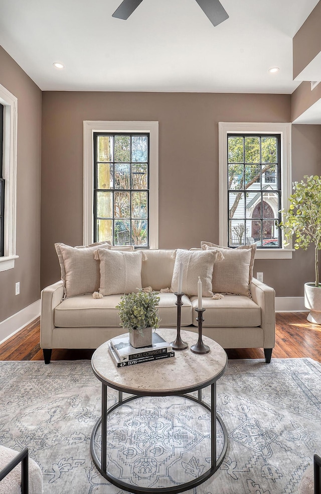 living area featuring a ceiling fan, recessed lighting, wood finished floors, and baseboards