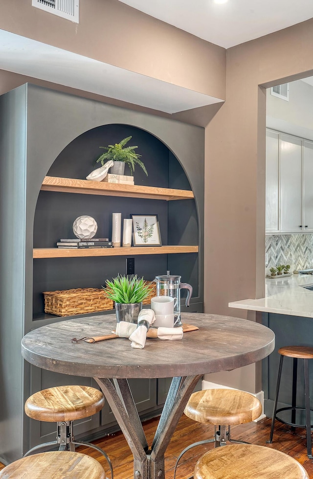 dining room featuring visible vents and wood finished floors