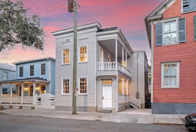 view of front of home featuring a porch and a balcony