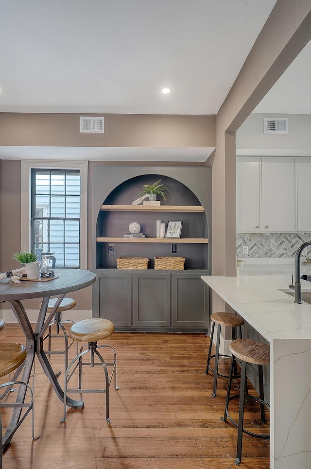 dining space featuring light wood-type flooring, visible vents, and recessed lighting