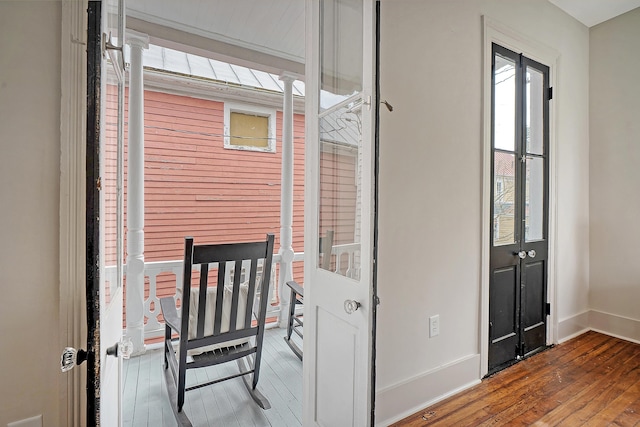 interior space featuring hardwood / wood-style floors and baseboards