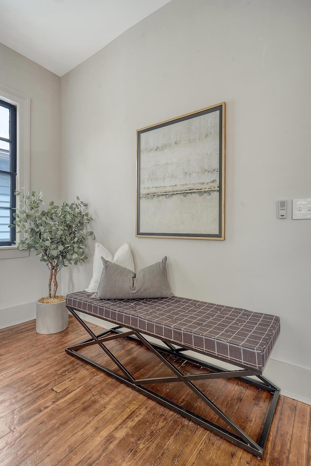 sitting room with wood finished floors and baseboards