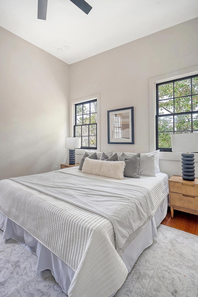 bedroom with ceiling fan and wood finished floors