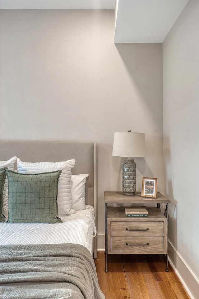 bedroom featuring baseboards and wood finished floors