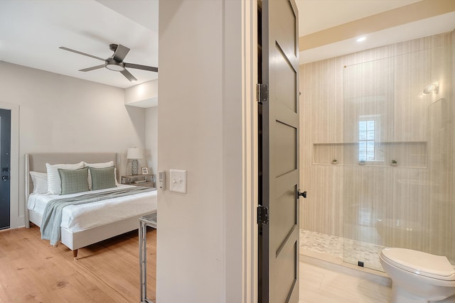 bedroom with light wood finished floors and a ceiling fan