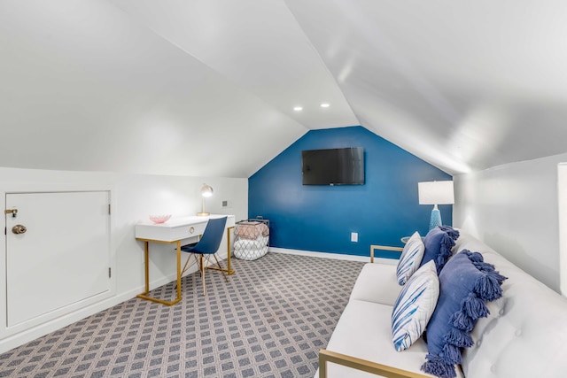 interior space featuring lofted ceiling and baseboards