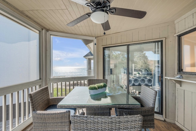 sunroom / solarium with wooden ceiling and a ceiling fan