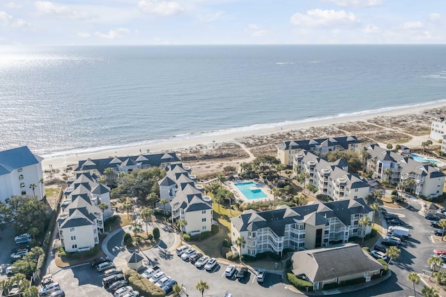 drone / aerial view featuring a beach view and a water view