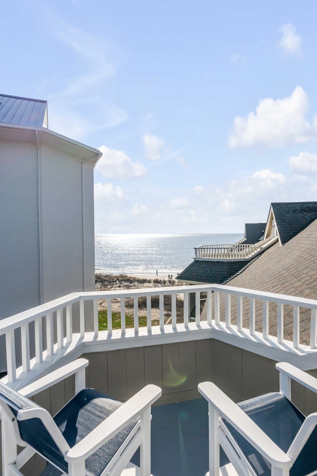 balcony with a beach view and a water view