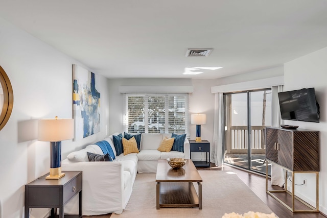 living area featuring wood finished floors and visible vents