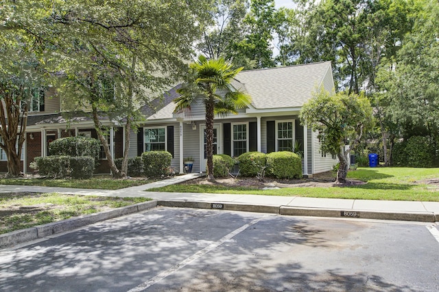 8059 Shadow Oak Dr, North Charleston, SC 29406 - view of front of property with uncovered parking, a shingled roof, and a front lawn
