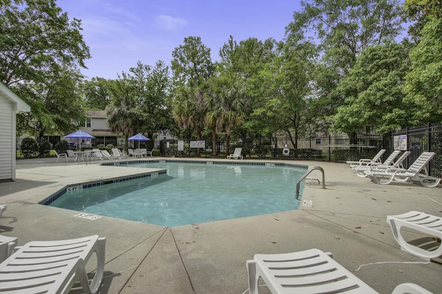 8059 Shadow Oak Dr, North Charleston, SC 29406 - community pool featuring a patio and view of wooded area