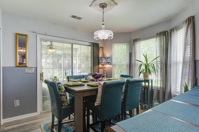 8059 Shadow Oak Dr, North Charleston, SC 29406 - dining space with wood finished floors and a chandelier