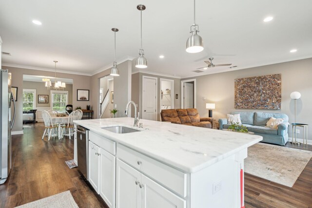 kitchen with ceiling fan with notable chandelier, sink, dark wood-type flooring, and an island with sink