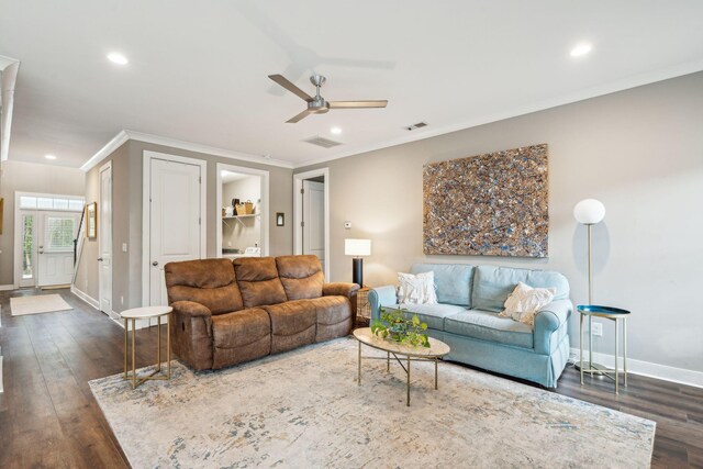 living room featuring crown molding, dark wood-type flooring, and ceiling fan