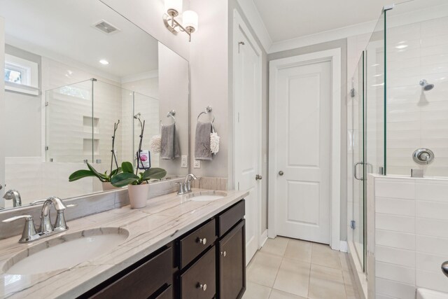 bathroom with tile patterned floors, walk in shower, and vanity