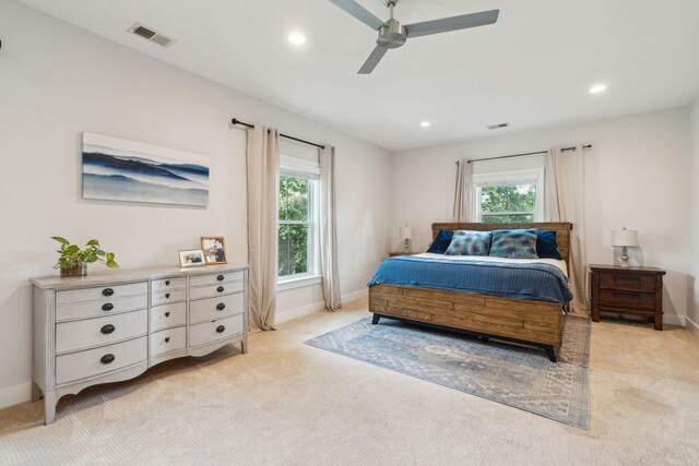 bedroom with light carpet and ceiling fan