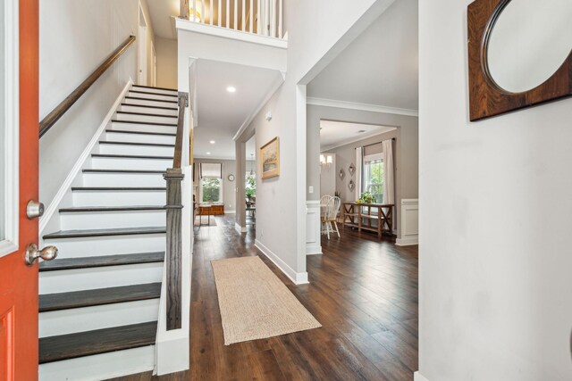 entryway featuring ornamental molding and dark hardwood / wood-style floors