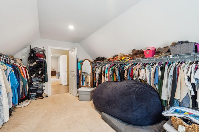 spacious closet featuring light carpet and lofted ceiling