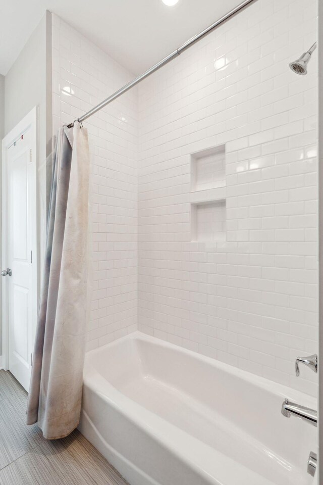 bathroom featuring shower / bathtub combination with curtain and tile patterned floors