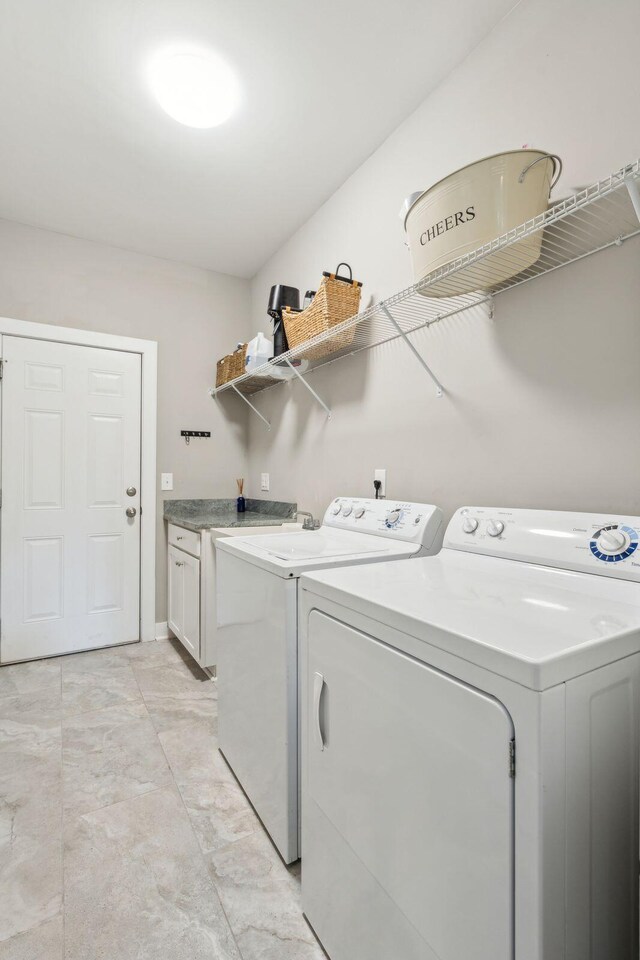 laundry area with cabinets and washing machine and dryer