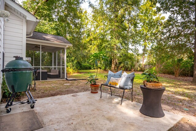 view of patio / terrace with ceiling fan and a sunroom