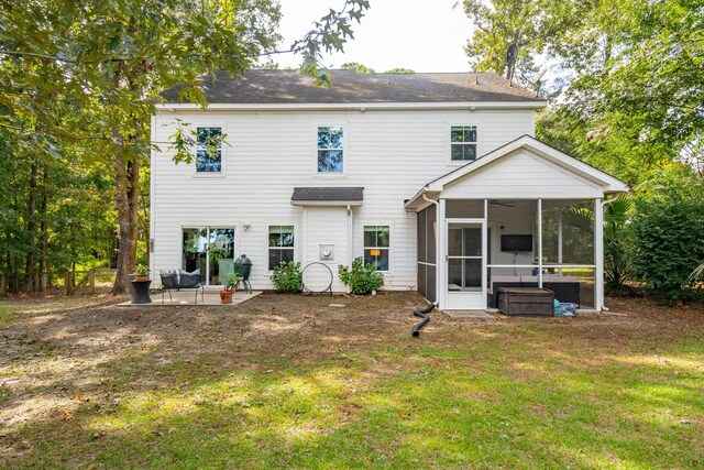 rear view of property with a sunroom, a yard, and a patio