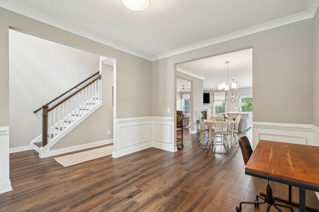 interior space with a chandelier, dark hardwood / wood-style floors, and crown molding