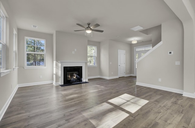 5629 Ellington School Rd, Ravenel, SC 29470 - unfurnished living room featuring ceiling fan, wood finished floors, a fireplace with flush hearth, and baseboards