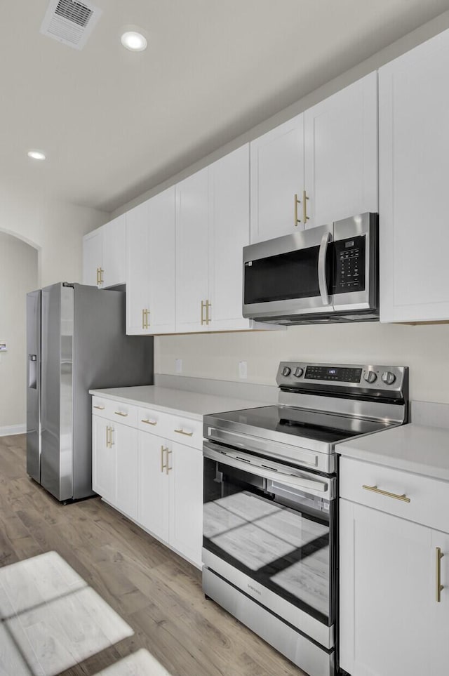 5629 Ellington School Rd, Ravenel, SC 29470 - kitchen featuring stainless steel appliances, light wood-type flooring, light countertops, white cabinets, and recessed lighting