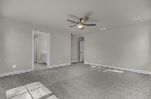 5629 Ellington School Rd, Ravenel, SC 29470 - empty room with arched walkways, a ceiling fan, light colored carpet, and baseboards