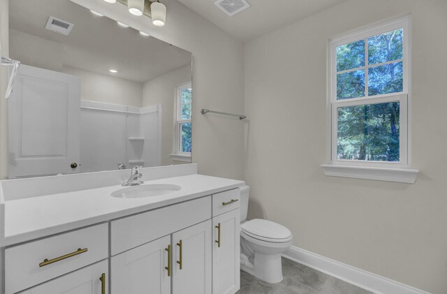 5629 Ellington School Rd, Ravenel, SC 29470 - full bath featuring vanity, plenty of natural light, baseboards, and toilet
