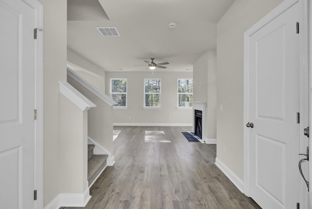 5629 Ellington School Rd, Ravenel, SC 29470 - hall with stairs, wood finished floors, and baseboards