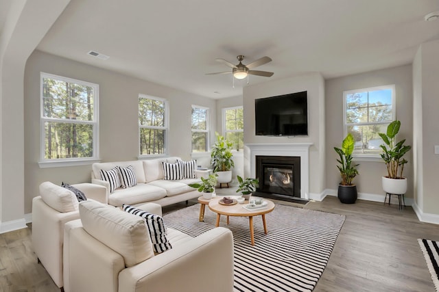 5629 Ellington School Rd, Ravenel, SC 29470 - living room with a ceiling fan, a fireplace with flush hearth, baseboards, and wood finished floors