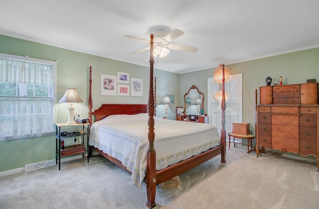 bedroom with ornamental molding, a ceiling fan, light carpet, and baseboards