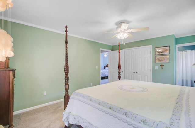 carpeted bedroom featuring a ceiling fan, crown molding, and baseboards