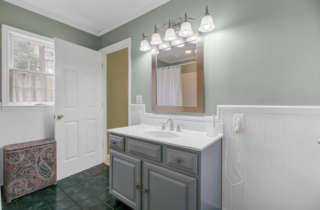 bathroom featuring a wainscoted wall, vanity, crown molding, and tile patterned flooring