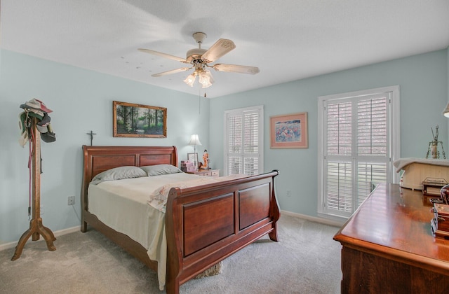 bedroom with light carpet, baseboards, and ceiling fan